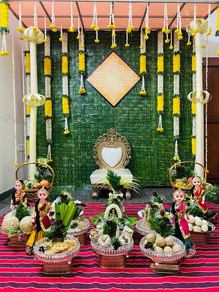 Seemantham stage with banana-leaf backdrop, marigold garlands, and traditional plated trays